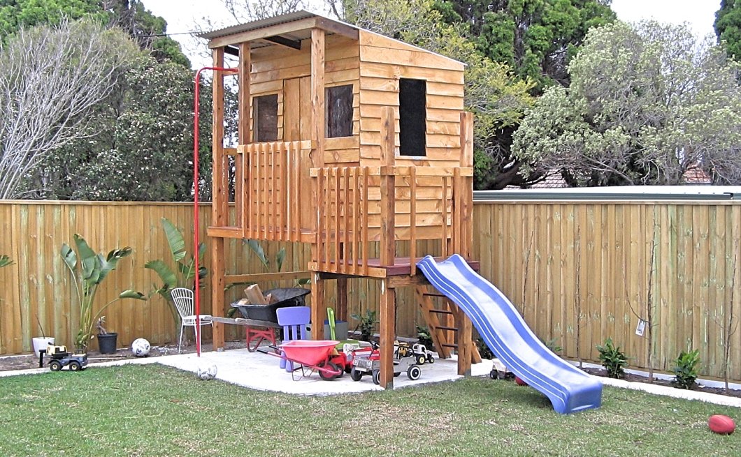 Timber cubby house on stilts with slippery slide and fire pole 